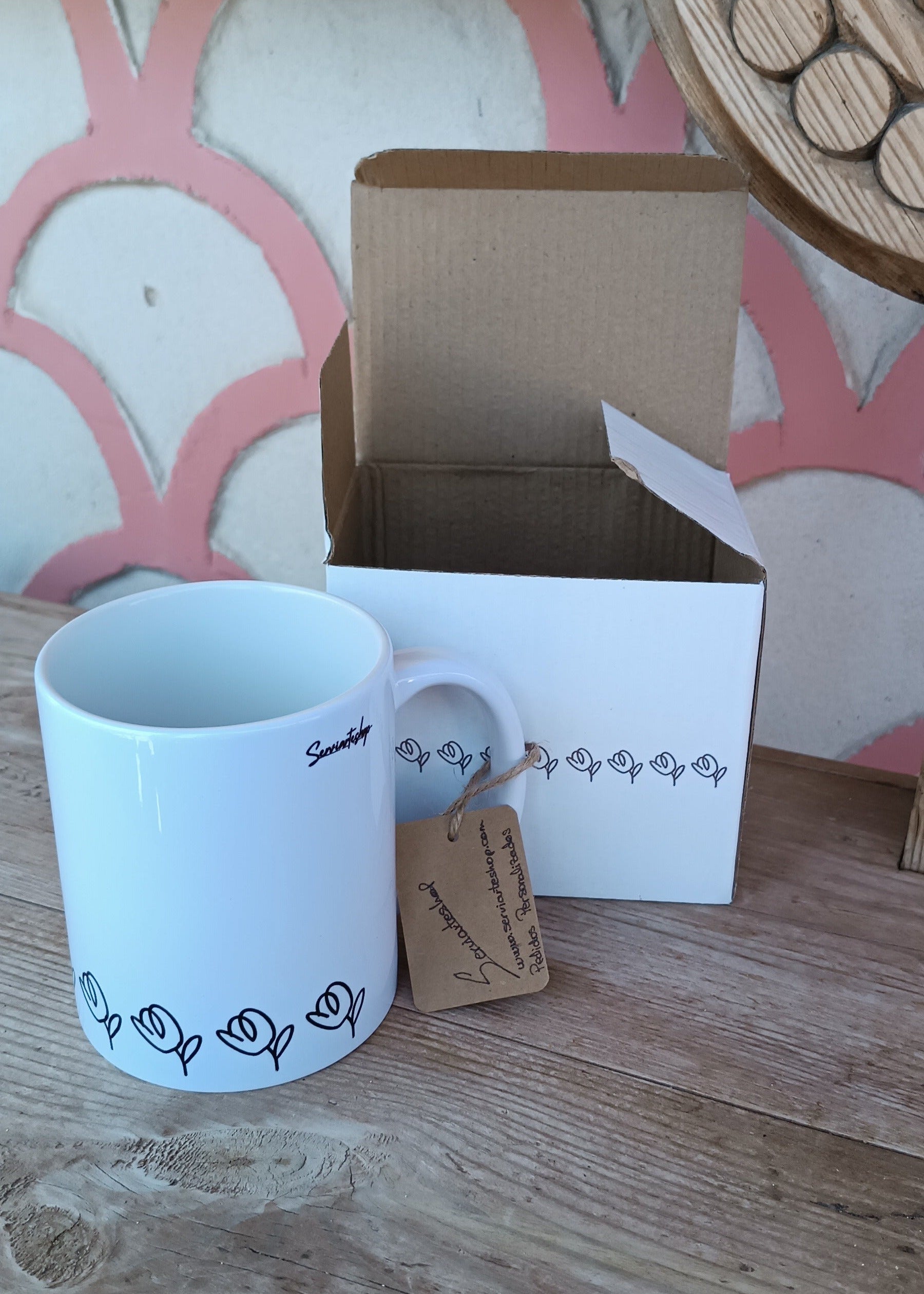 “Suspiro de Tulipán”: una taza con arte en línea continua que dibuja tulipanes negros en un susurro visual, acompañada de su caja a juego y una etiqueta de papel kraft que envuelve la pieza con un toque artesanal.